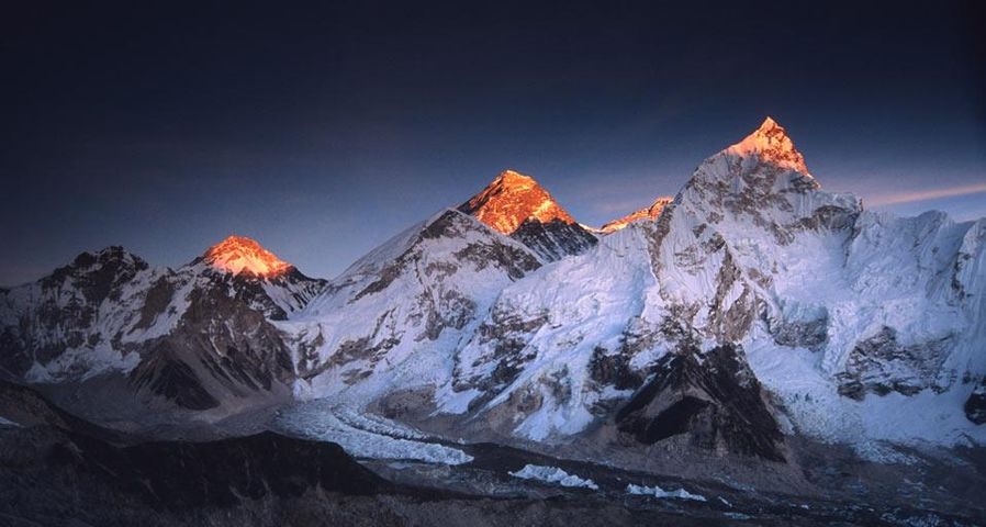 The day's last light touches the summit of Mt. Everest and other nearby peaks in Sagarmāthā National Park, Nepal