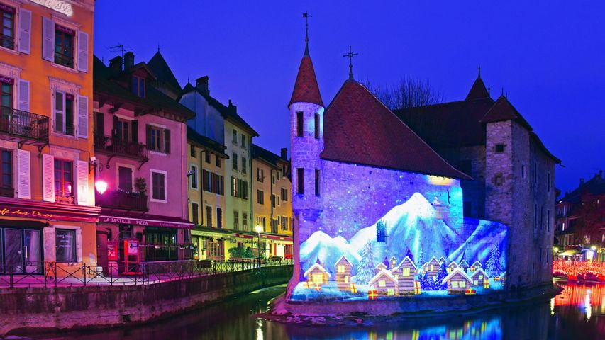 Winter scene illuminated on the Palais de l'Isle in Annecy, Haute Savoie, France