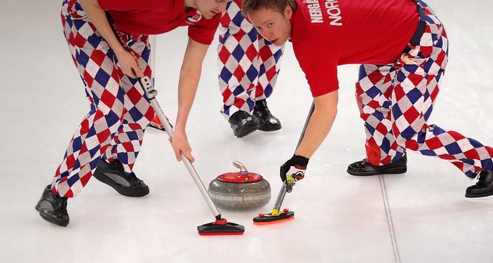 Haavard Vad Petersson and Torger Nergaard of Norway sweep a path for the stone during the Men's Curling at the Vancouver 2010 Winter Olympics on February 16, 2010