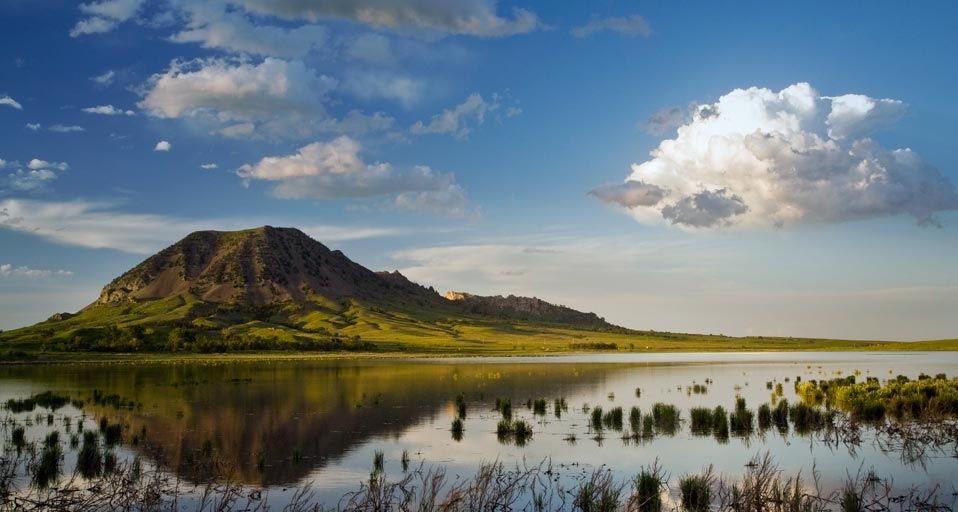 Bear Butte reflects into Bear Butte Lake near Sturgis, South Dakota