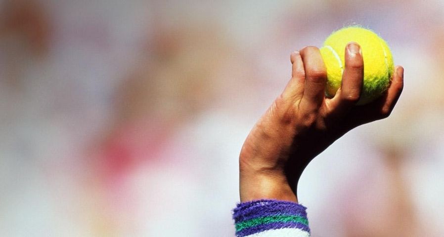 Ballboy's hand holding ball aloft, Wimbledon, England