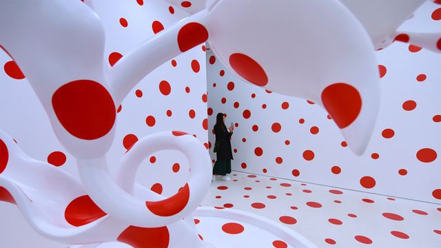 A woman looks at Yayoi Kusama's 'With All My Love for The Tulips, I Pray Forever (2011)'