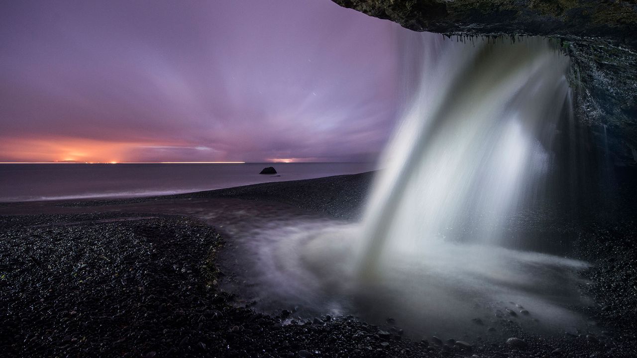 View of a waterfall at Mystic Beach in Juan de Fuca Provincial Park, B.C. during dusk