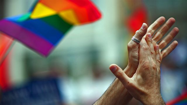 Rainbow flag and clapping hands, New York City