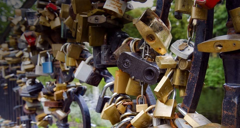 Padlocks, affixed to a bridge by sweethearts, in Bastejkalns Park, Riga, Latvia
