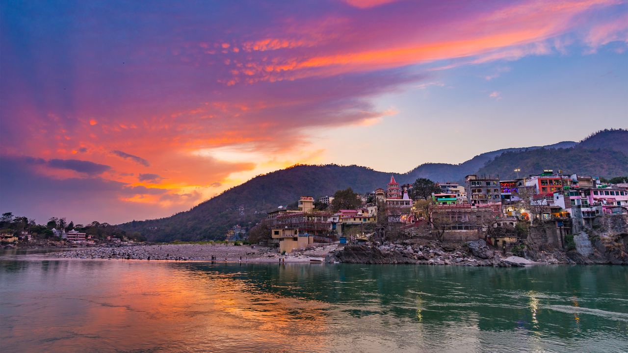 Colourful sky and clouds reflecting over the Ganges River, Rishikesh