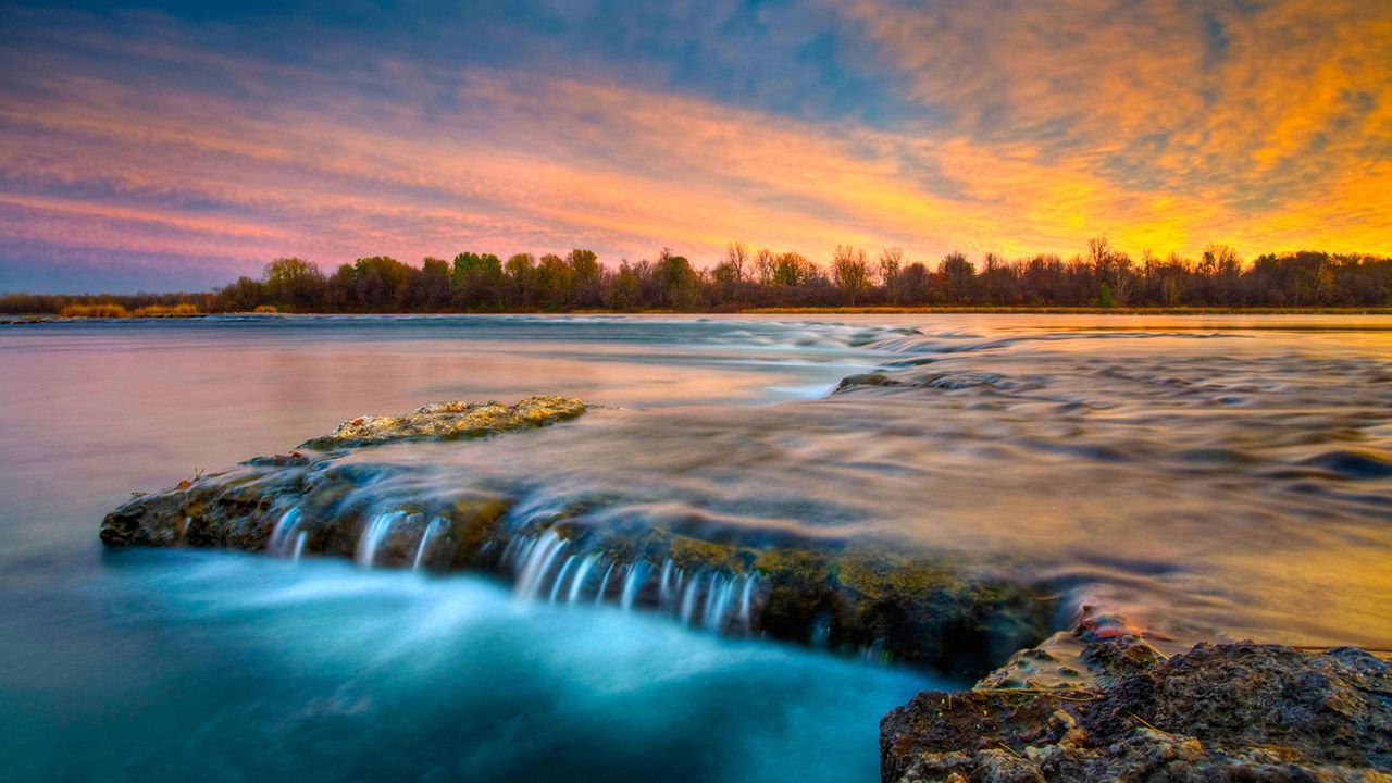 River flowing over rocks at twilight, Coteau du Lac, Quebec, Canada