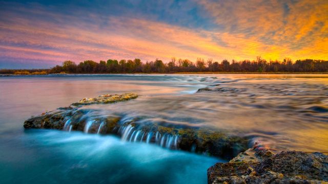 River flowing over rocks at twilight, Coteau du Lac, Quebec, Canada