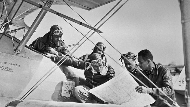 Tuskegee Airmen reading a map