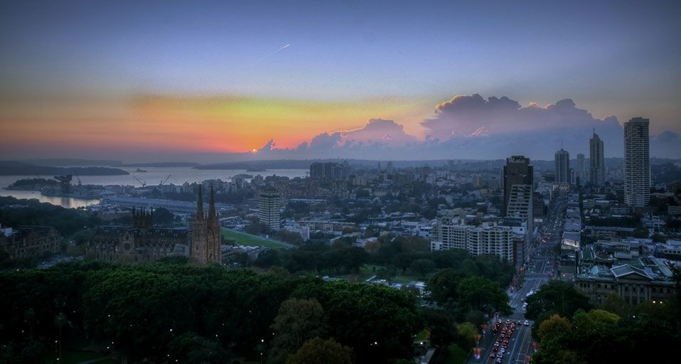 The first rays of sun pouring through a cloud formation over eastern Sydney, Australia