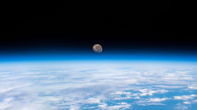 Waning gibbous moon above the Earth's horizon, photographed from the International Space Station