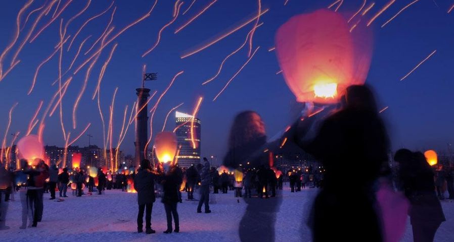 Long-exposure photograph of people launching paper lanterns on International Women's Day, St. Petersburg, Russia