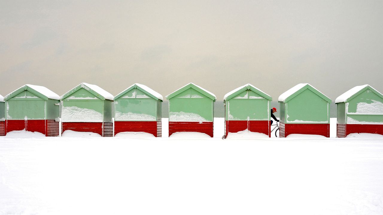 Beach huts covered in snow in Brighton and Hove, England