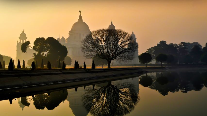 Beautiful foggy winter sunrise at Victoria Memorial, Kolkata, India.