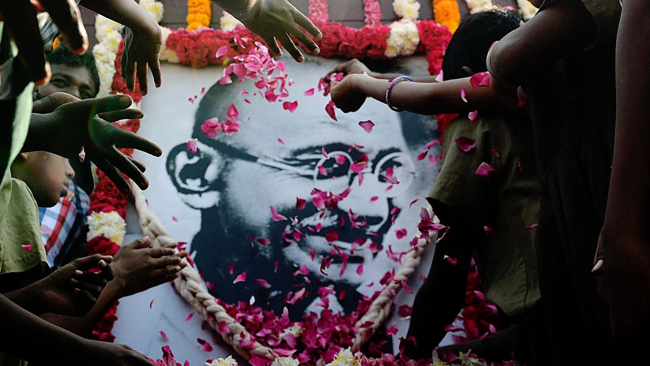 School children pay homage to a portrait of Mahatma Gandhi on Martyr's Day.