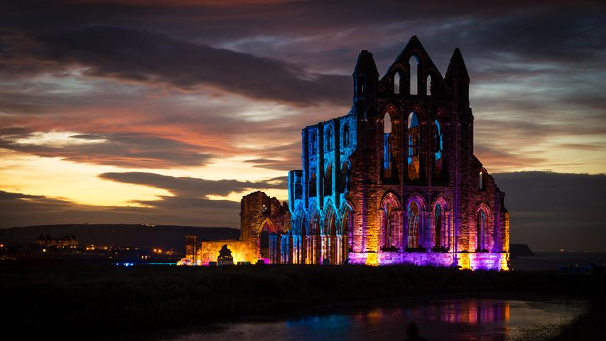 Whitby Abbey illuminated with coloured floodlights in North Yorkshire