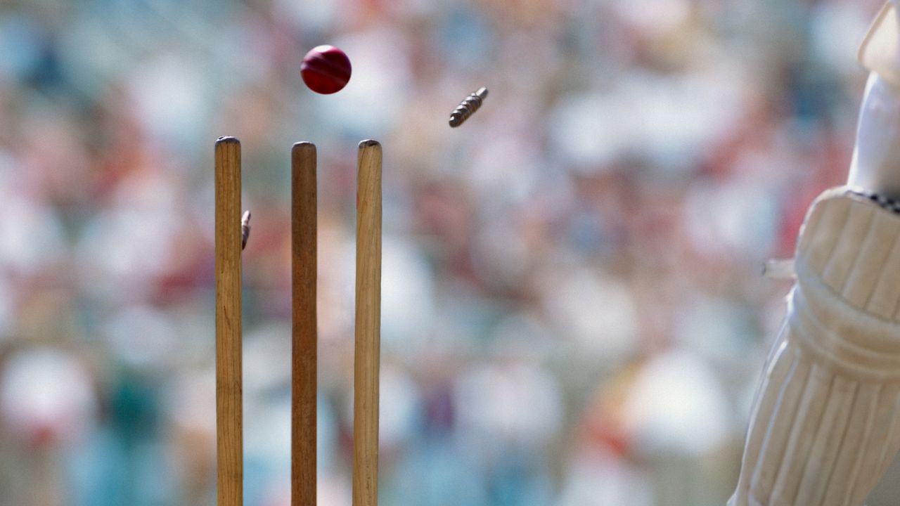 A cricket ball striking the wicket 