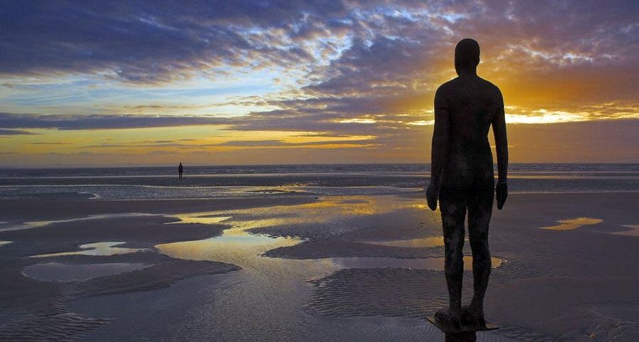 “Another Place” statues by artist Antony Gormley on Crosby Beach, Merseyside, England