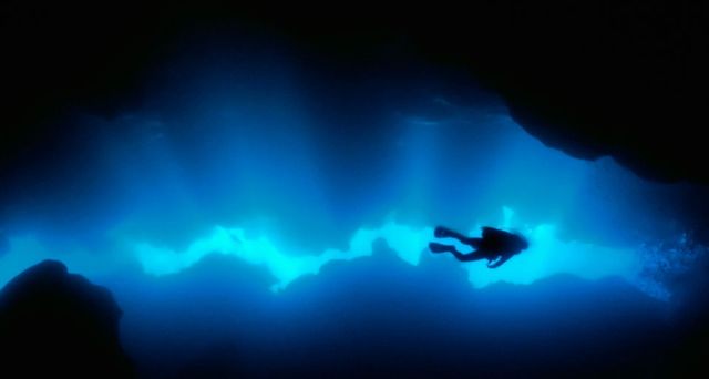Diver in a grotto off of Roatan Island, Honduras