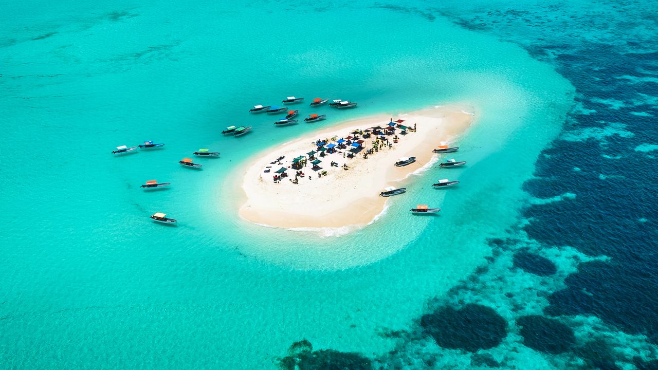 White sand sandbank, turquoise water, boats