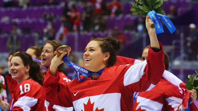 Gold medalist Natalie Spooner #24 of Canada celebrates during the medal ceremony after defeating the the United States 3-2 in overtime during the Ice Hockey Women's Gold Medal Game on day 13 of the Sochi 2014 Winter Olympics at Bolshoy Ice Dome on February 20, 2014 in Sochi, Russia.