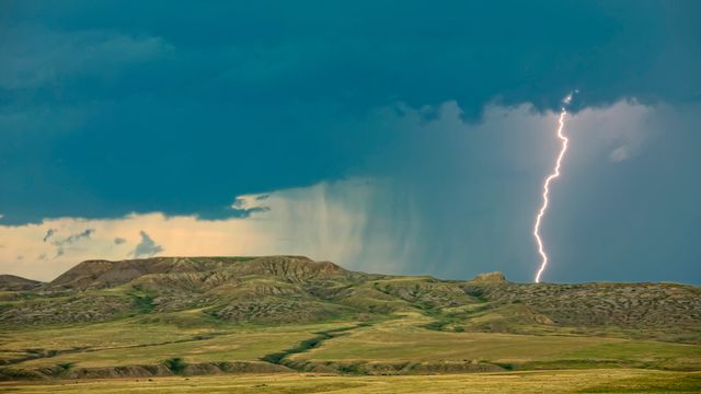 Lightning striking over 70 Mile Butte and Sleeping Lion Butte, Grasslands National Park, Saskatchewan