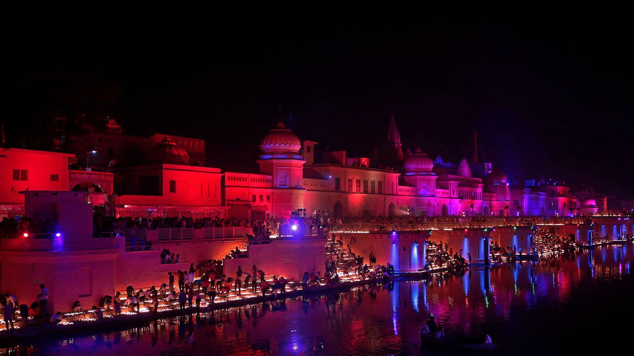 Devotees light oil lamps on the banks of the Sarayu River in Ayodhya, India