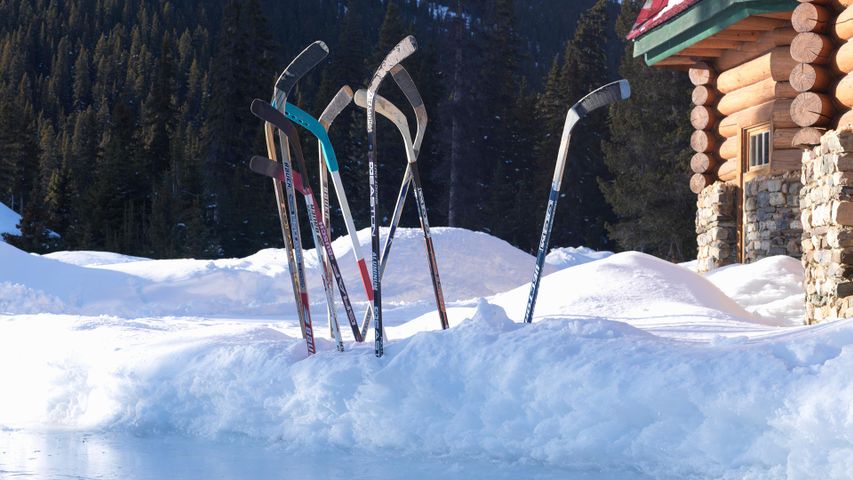 Ice hockey sticks in snow, Banff, Alta.