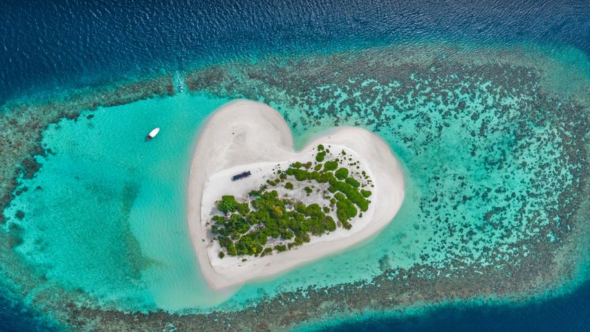 Heart-shaped island with sandy beach, offshore coral reef, Indian Ocean, Maldives