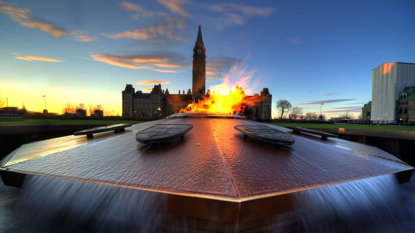 Parliament of Canada with eternal flame in foreground in Ottawa 