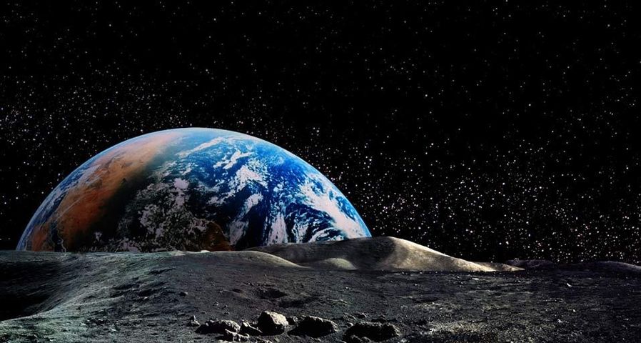 Photo composite of Earth rising above the lunar horizon