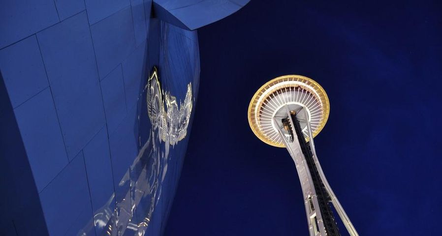 The Space Needle and its reflection on the surface of the EMP Museum in Seattle, Washington, U.S.A.