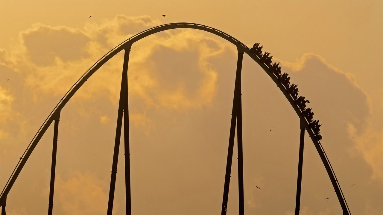 Silhouette of Shambhala roller coaster at sunset in PortAventura Park, Salou, Tarragona, Spain
