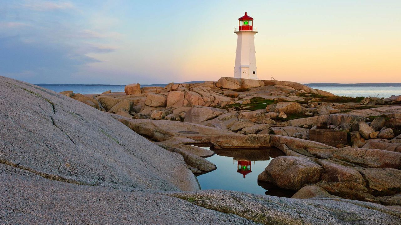 Lighthouse reflected in a pool of water at Peggy's Cove, N.S. 