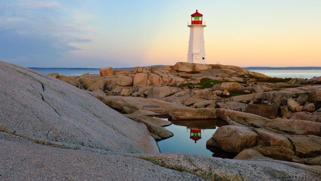 Lighthouse reflected in a pool of water at Peggy's Cove, N.S. 