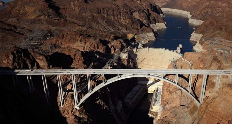 An aerial view shows part of the Hoover Dam Bypass Project in front of the Hoover Dam in the Lake Mead National Recreation Area, Nevada