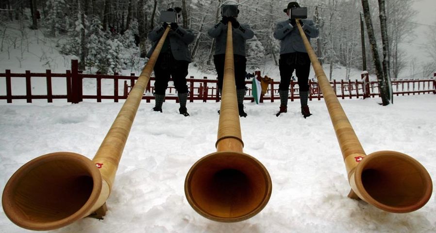 Three alphorn players from the International Alphorn Society perform in Fort Kent, Maine