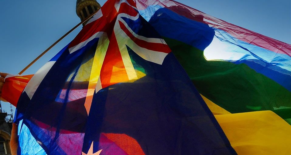 A protester shows his colours during a gay rights march through Sydney