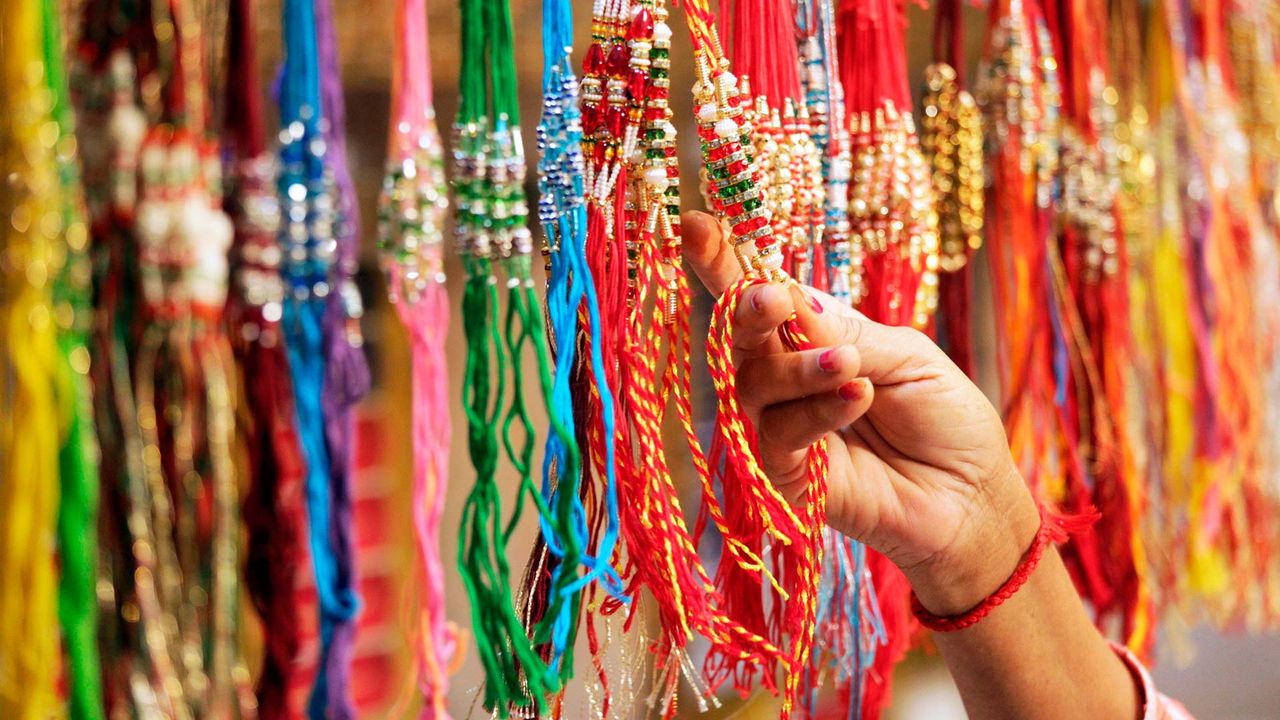Woman shops for 'rakhis' in a market ahead of Raksha Bandhan.
