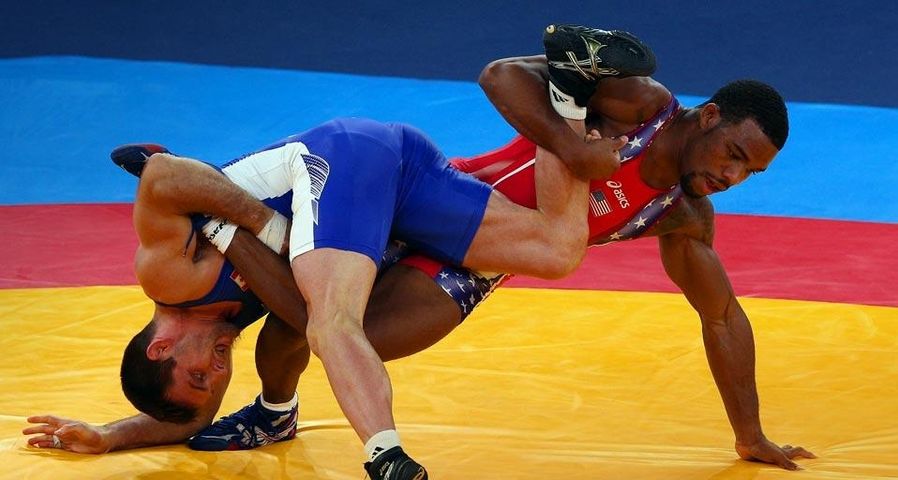 Jordan Ernest Burroughs of the United States competes with Matthew Judah Gentry of Canada during the men's freestyle 74-kg wrestling quarterfinal bout in London, England
