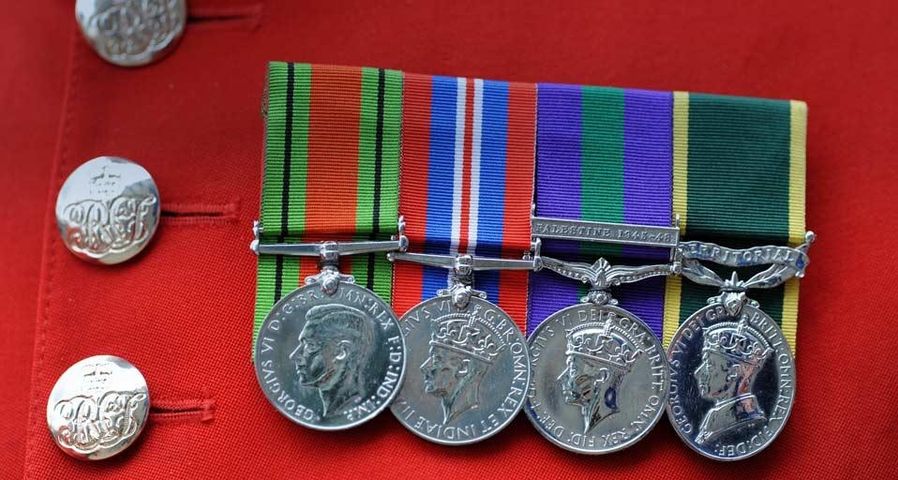 Detail of medals on a Chelsea Pensioner's traditional red uniform