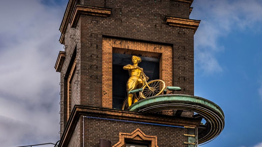 Vejrpigerne (The Weather Girls) sculpture on top of the Richshuset building in City Hall Square in Copenhagen, Denmark