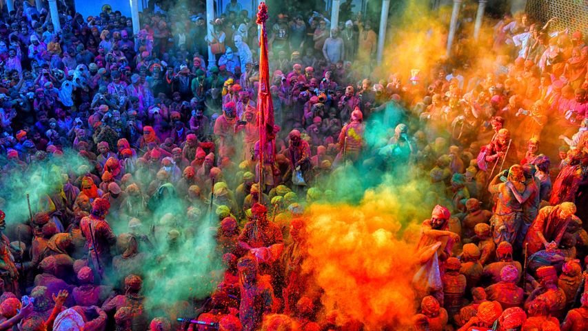Hindu devotees play with colourful powders during Holi, India