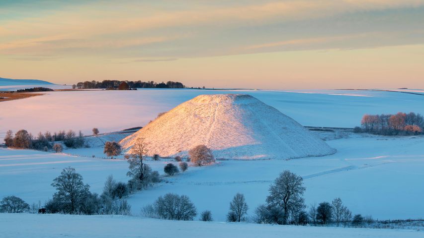 Silbury Hill in the winter snow at sunrise, Avebury, Wiltshire