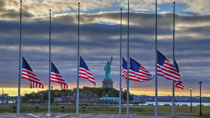 Statue of Liberty seen behind US flags at half-staff for the anniversary of September 11 in 2014, New York City