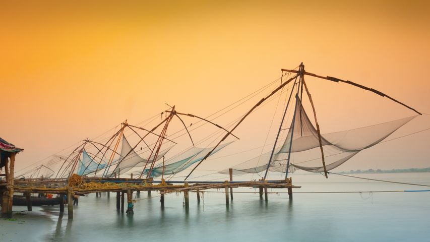 Traditional chinese fishing nets in Kochi, India at sunrise.