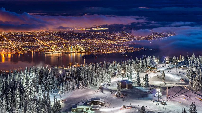 City lights from the snowy peak of Grouse Mountain at twilight, Vancouver