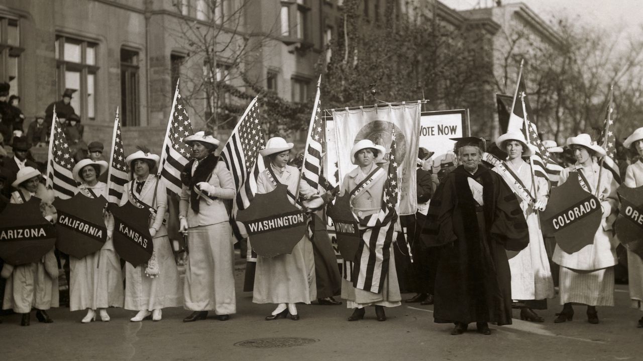 Dr. Anna Howard Shaw leading a suffrage parade in 1910s New York City