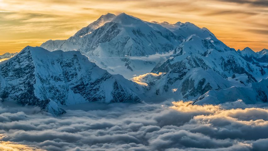 Aerial image of Mount Logan rising above the clouds in Kluane National Park, Yukon