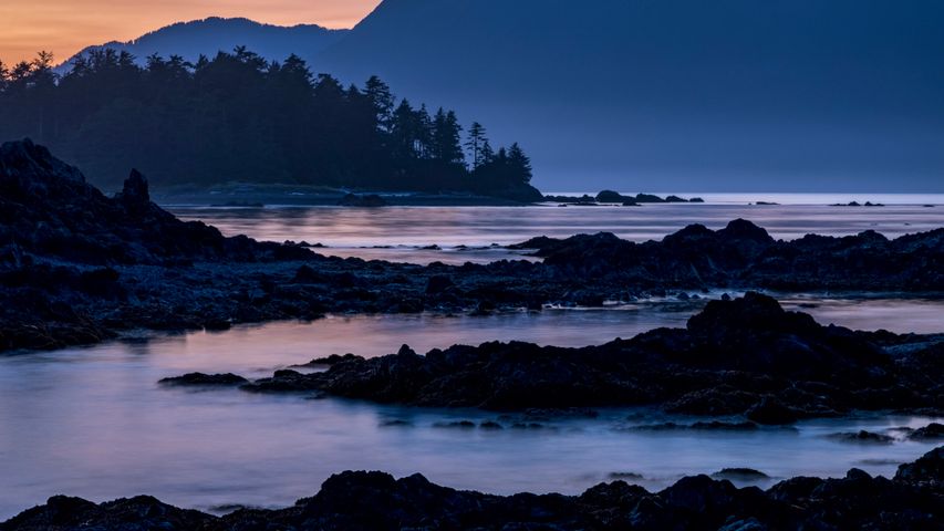 Dusk falls over Vancouver Island viewed from an islet in Nuchatlitz Provincial Park, British Columbia